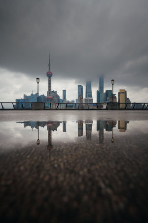 Shanghai city skyline view with overcast sky and water reflections in Chinaの写真素材