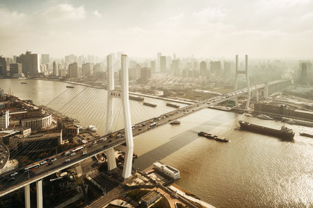 Shanghai Nanpu Bridge over Huangpu River with busy traffic in China.の写真素材