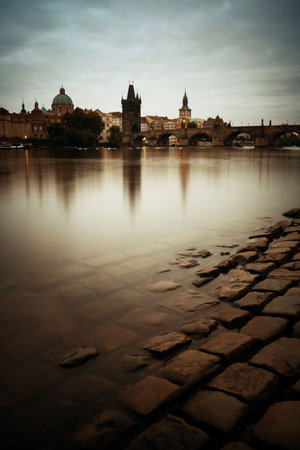 Prague skyline and bridge over river in Czech Republic at night.の写真素材