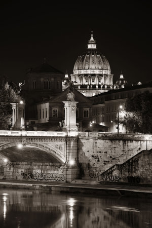 River Tiber in Rome with Vatican City St Peters Basilica and Ponte Vittorio Emanuele II at nightの写真素材