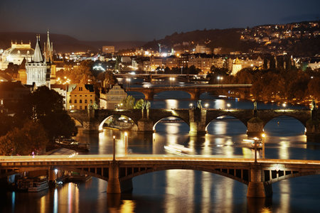 Prague skyline and bridge over river in Czech Republic at night.の写真素材