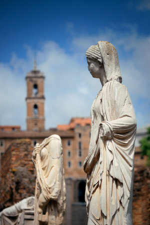 Rome Forum with ruins of historical buildings and statue in garden. Italy.の写真素材