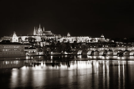 Prague skyline and bridge over river in Czech Republic at night.の写真素材