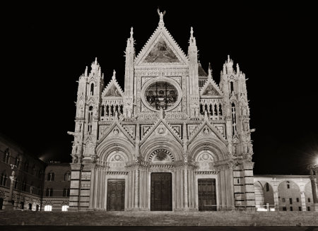 Siena Cathedral closeup as the famous landmark in medieval town at night in Italy.の写真素材