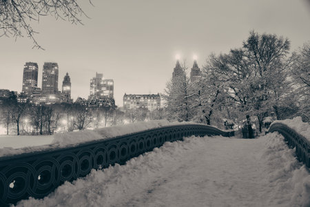 Central Park winter with skyscrapers and Bow Bridge in midtown Manhattan New York Cityの写真素材