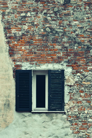 Vintage window with brick texture closeup in medieval Town Lucca in Italy.の写真素材