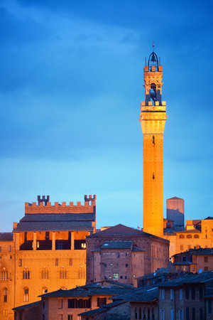 Medieval town Siena skyline view with Bell Tower and historic buildings in Italy at nightの写真素材