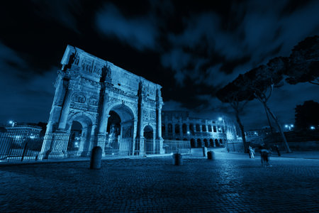 Arch of Constantine and Colosseum at night in Rome, Italy.の写真素材