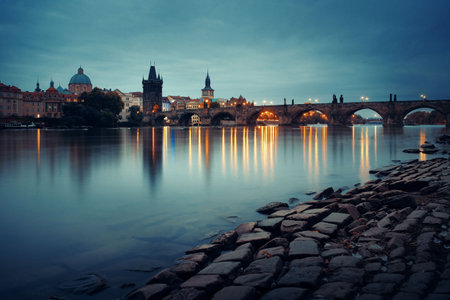 Prague skyline and bridge over river in Czech Republic at night.の写真素材