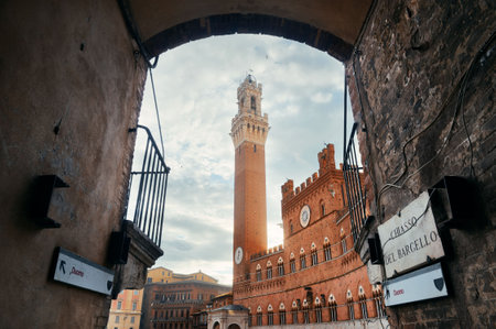 City Hall Bell Tower viewed from archway in Siena Italy.の写真素材