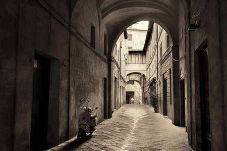 Street view with old buildings and archway in Siena, Italy.の写真素材