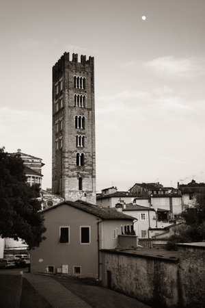 Basilica di San Frediano in Lucca with historic buildings in Italy.の写真素材