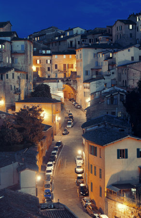 Old medieval town Siena in Italy at nightの写真素材