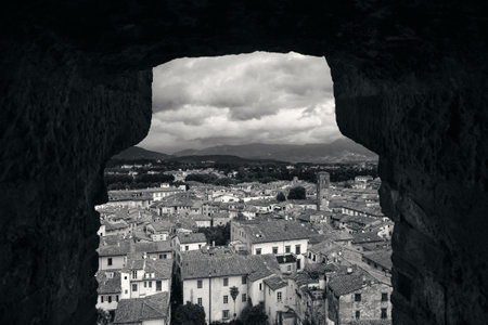 Lucca town skyline rooftop view through window in Italy.の写真素材