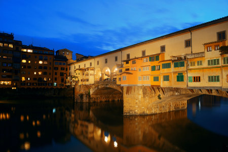 Ponte Vecchio over Arno River at night in Florence Italy.の写真素材
