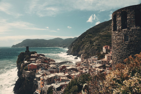 Vernazza with buildings on rocks over sea in Cinque Terre, Italy.の写真素材