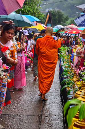 05 July 2020 , People come to offer food to monks on Asanha Bucha Day in Sangkhlaburi, Kanchanaburi, Thailand.のeditorial素材