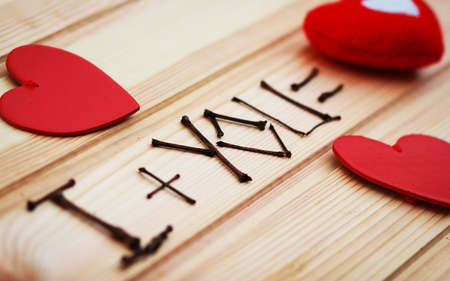 Love you! text on wood with red hearts. The idea of communication with a loved one, declaration of love! valentine Day.の写真素材