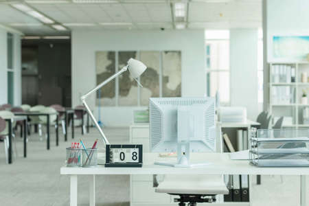Interior of a modern office with computer and white furnitureの写真素材