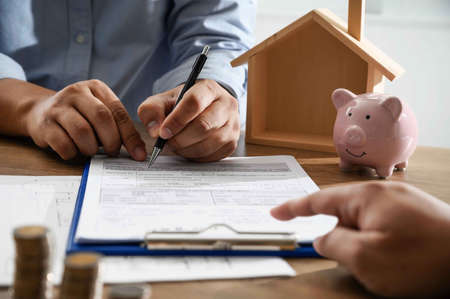 The of home ownership business people negotiating a contract this is where you need to sign
