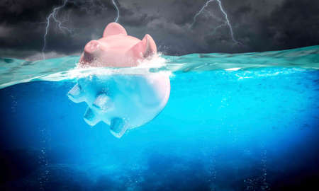 Piggybank floats in the stormy sea.の写真素材