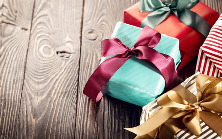 Wrapped amazing Christmas presents on the wooden floor.の写真素材