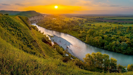 A river flowing through a valley. The scenery includes grass, trees, and mountains in the...