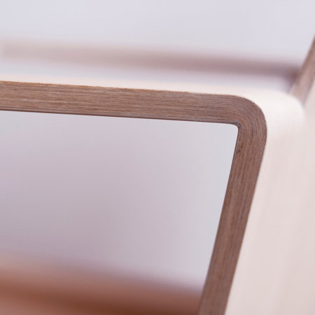 Closeup of a mirror on a wooden shelf in a living roomの写真素材