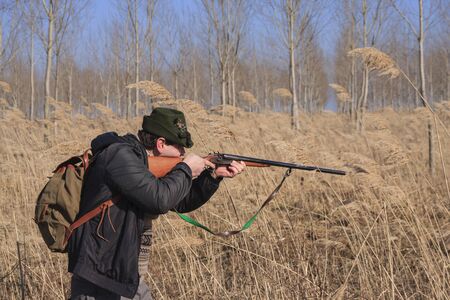 Hunter is preparing to shoot a wild boar