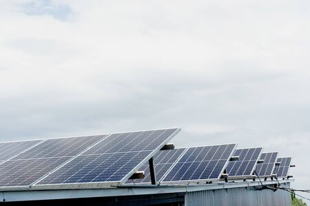 Solar panels stands in row on the roof . Free electricity for home. Sustainability of planet. Green...