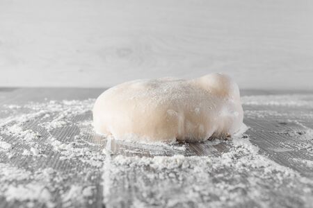 Wheat dough ball with flour. Cooking pizza with italian white dough. Food blanks in restaurant.の写真素材