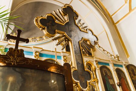 Huge Orthodox cross in the church interior. Orthodox tradition and faith. Equipment for praying. Pray for people life. Pray to godの写真素材