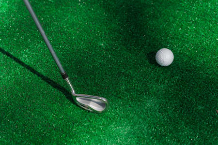 Niblick for playing mini golf sport game on the green grass. Advert for golf club. Mini games for childrenの写真素材