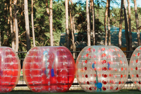 Bubble ball balloons on the green field. equipment for team building sport game named bumper ball or...