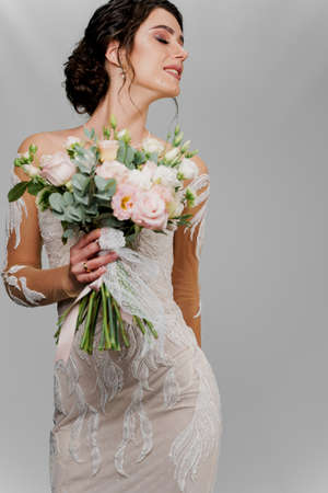 Close-up bride portrait with closed eyes in studio. Advert for social networks for wedding agency and bridal salonの写真素材
