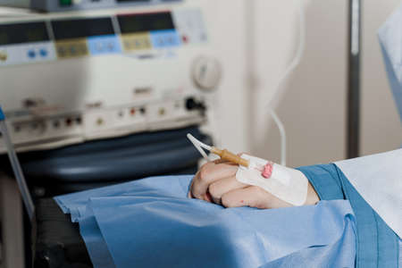 Catheter safely inserted into woman hand on plastic operation Anesthesia for surgery.の写真素材