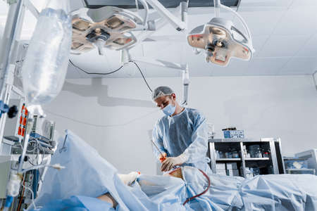 Abdominoplasty plastic operation to reduce the abdomen and remove cellulite. Correcting body shape. Surgeon does liposuction for patient in medical clinicの写真素材