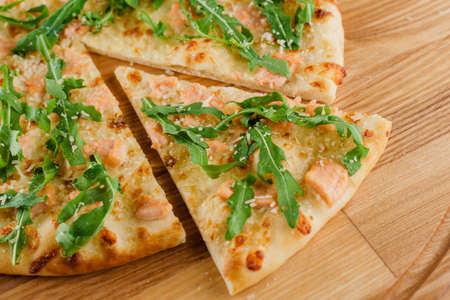 Pizza close-up on white wooden background. Food delivery for people who stay at home. Tasty fast...