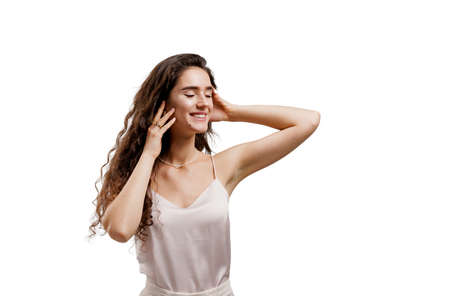 Attractive girl with clear skin and long wavy hair. Brunette with curly hairstyle. Young woman...