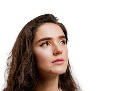 Attractive girl with clear skin and long wavy hair close-up. Brunette with curly hairstyle. Young...