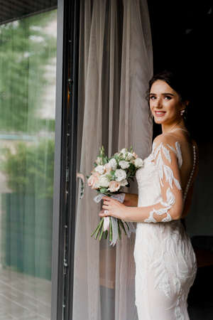 Bride in wedding dress and bridal veil in cafe. Advert for social networks for wedding agency and bridal salonの写真素材