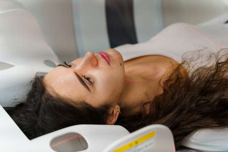 CT diagnosis of a girl with cancer. patient undergoes examination in the clinic using multispiral computed tomographyの写真素材