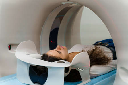 CT diagnosis of a girl with cancer. patient undergoes examination in the clinic using multispiral computed tomographyの写真素材