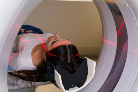 Red rays scan the girl on a CT scan of the lungs and mediastinal organs. Checking the condition of the vessels, trachea and bronchi of a womanの写真素材