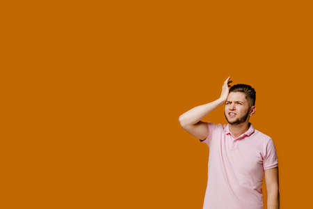Remedy from headache of young bearded man. Student touches his head because he has a headache. Empty...