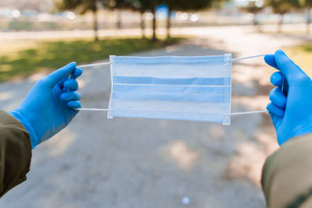 Quarantine measures in the period of epidemy of virus. Blue medical mask and medical gloves.