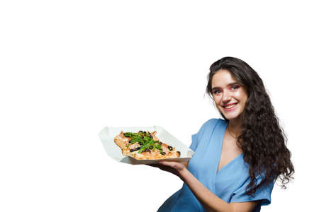 Girl courier with pinsa romana and scrocchiarella gourmet italian cuisine on white background. Holding traditional dish. Food delivery from pizzeria. Pinsa with meat, arugula, olives, cheese.の写真素材