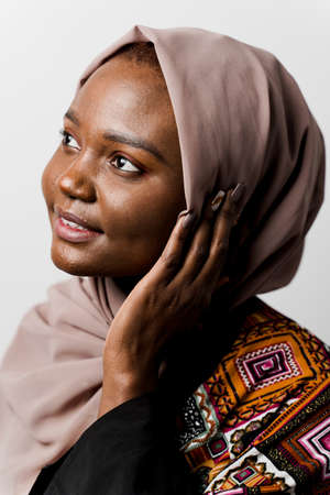 Dreamy black girl weared hijab smile and rejoice on white background. Muslim happy woman posing in studio. Attractive african female.の写真素材