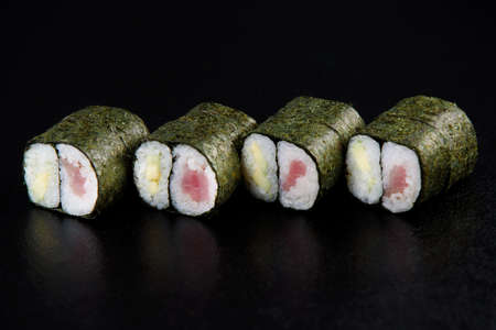 Fresh delicious Japanese sushi with avocado, cucumber, shrimp and caviar on dark backgroundの写真素材