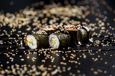 Fresh delicious Japanese sushi with avocado, cucumber, shrimp and caviar on dark backgroundの写真素材